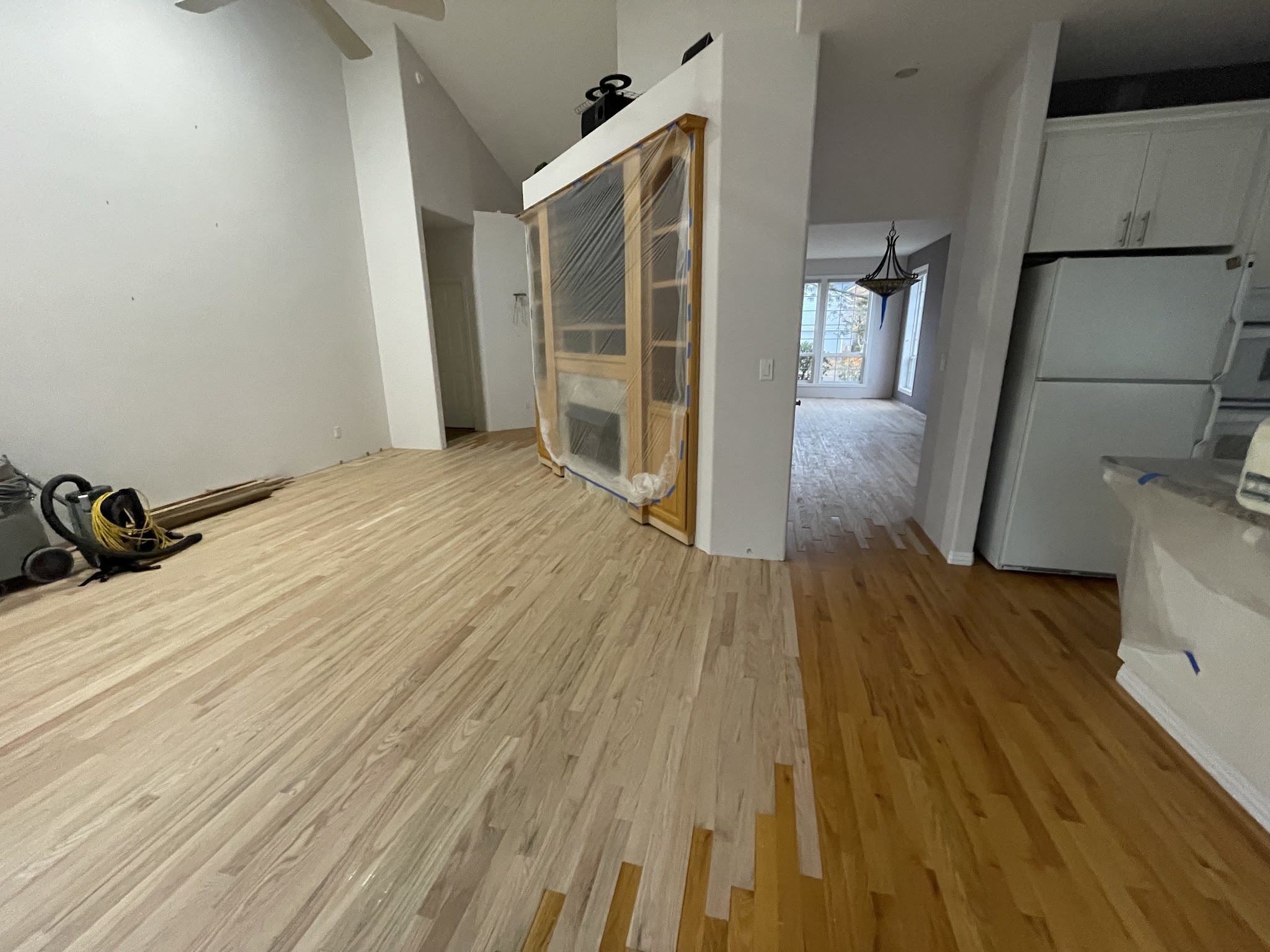 Hardwood installation in progress showing new boards matched into the existing floor