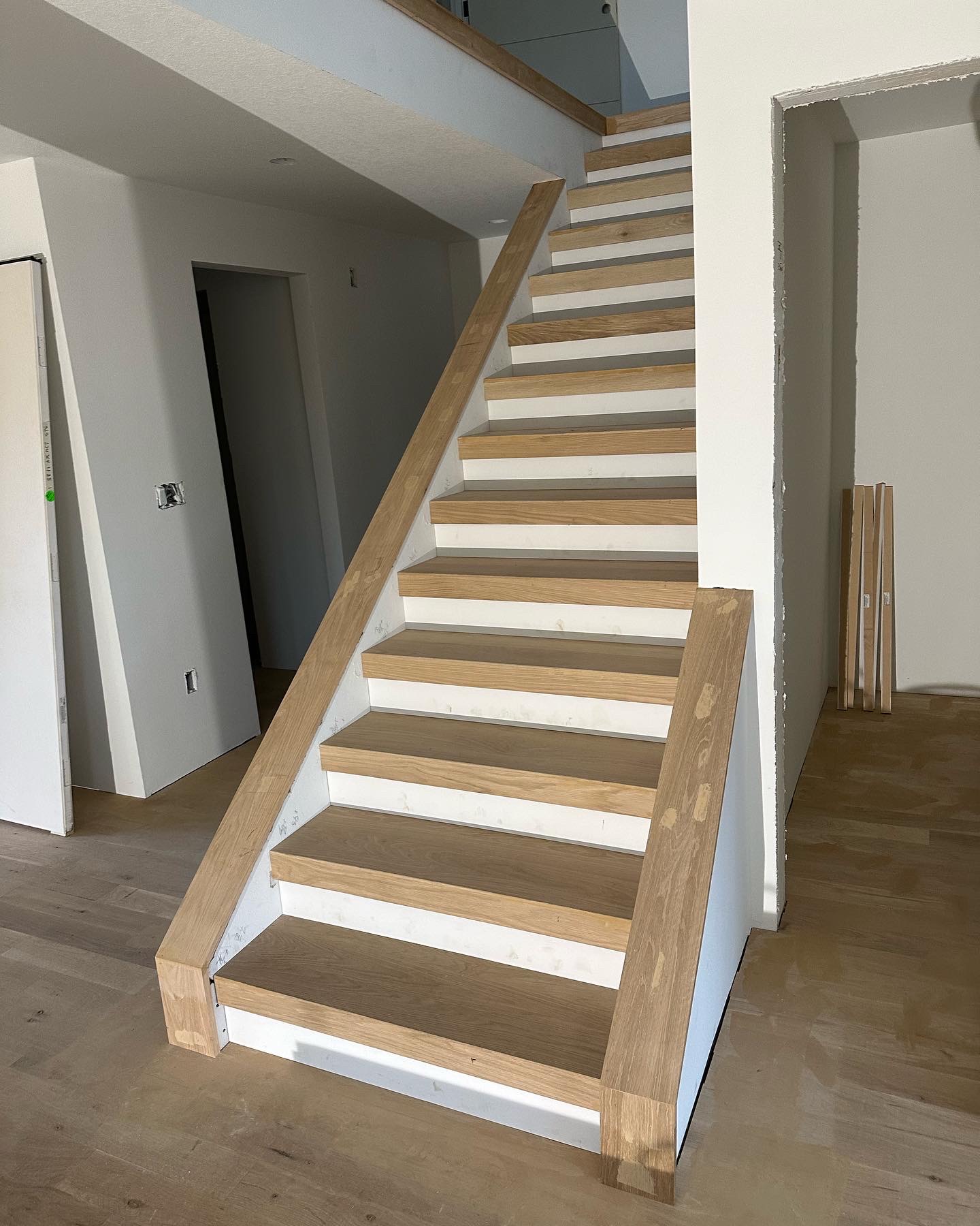 Modern staircase build with oak treads and white risers