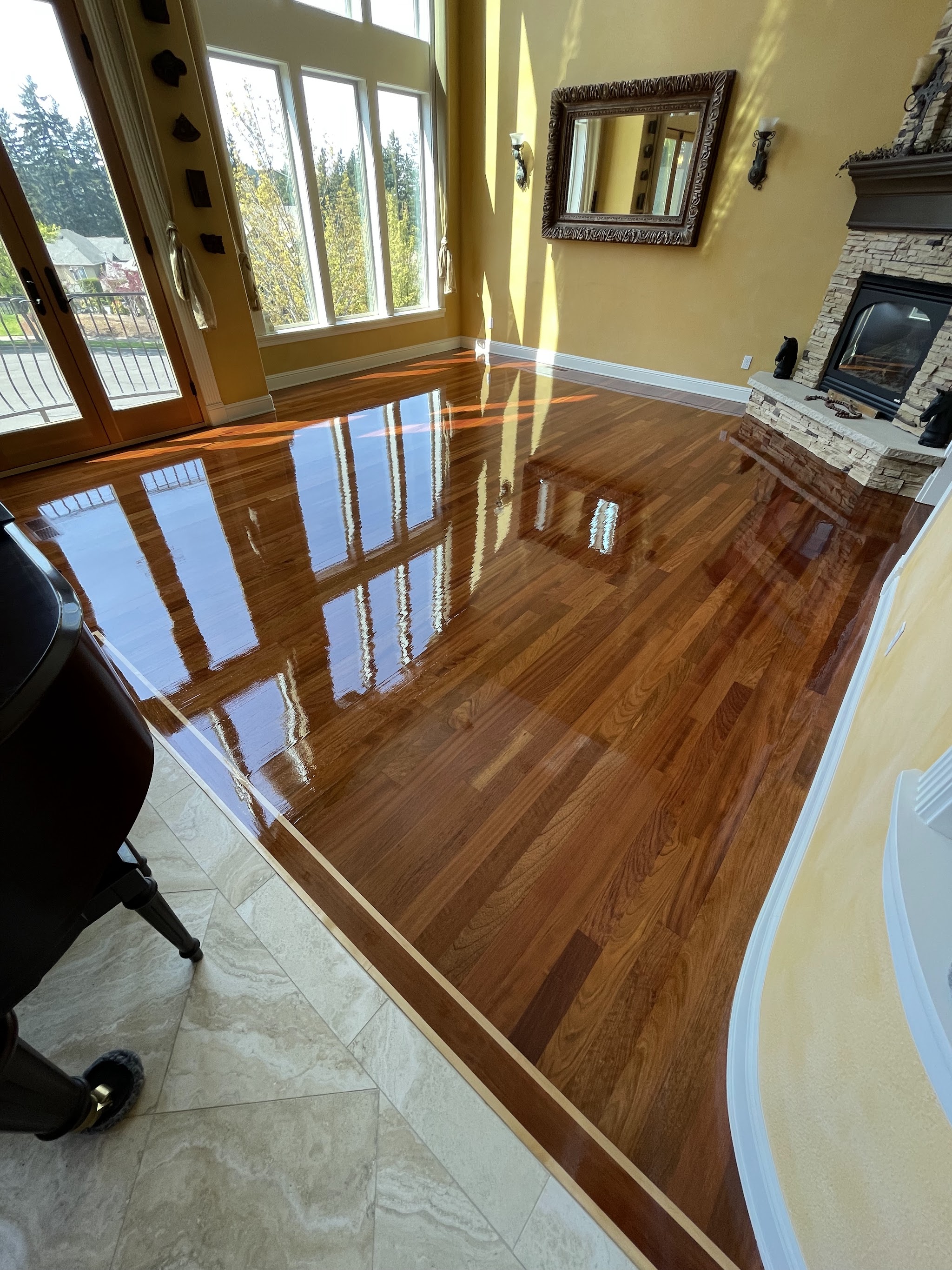 High gloss finished hardwood floor in a formal living room with fireplace