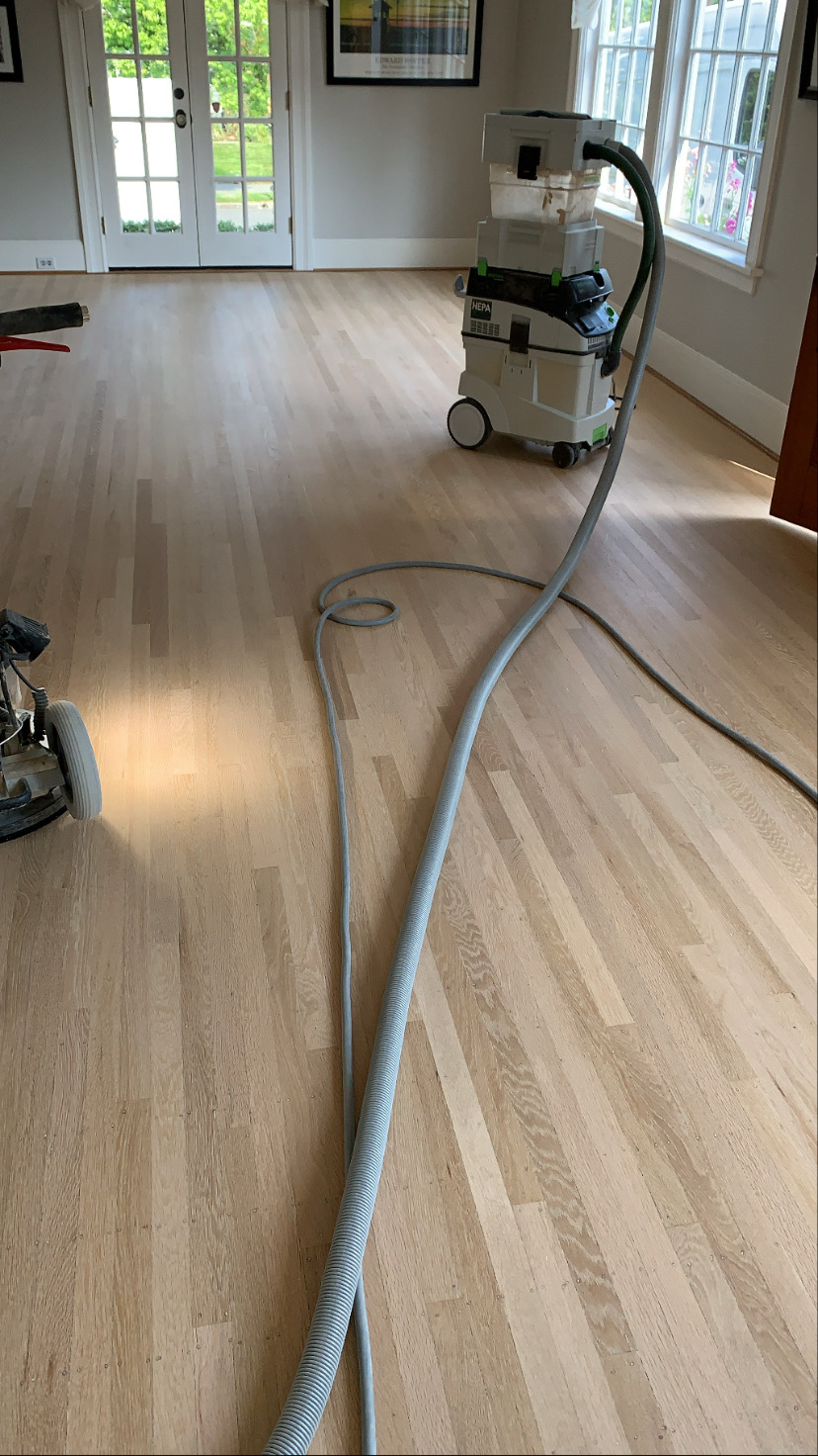 Floor sanding underway with a HEPA dust extraction unit running