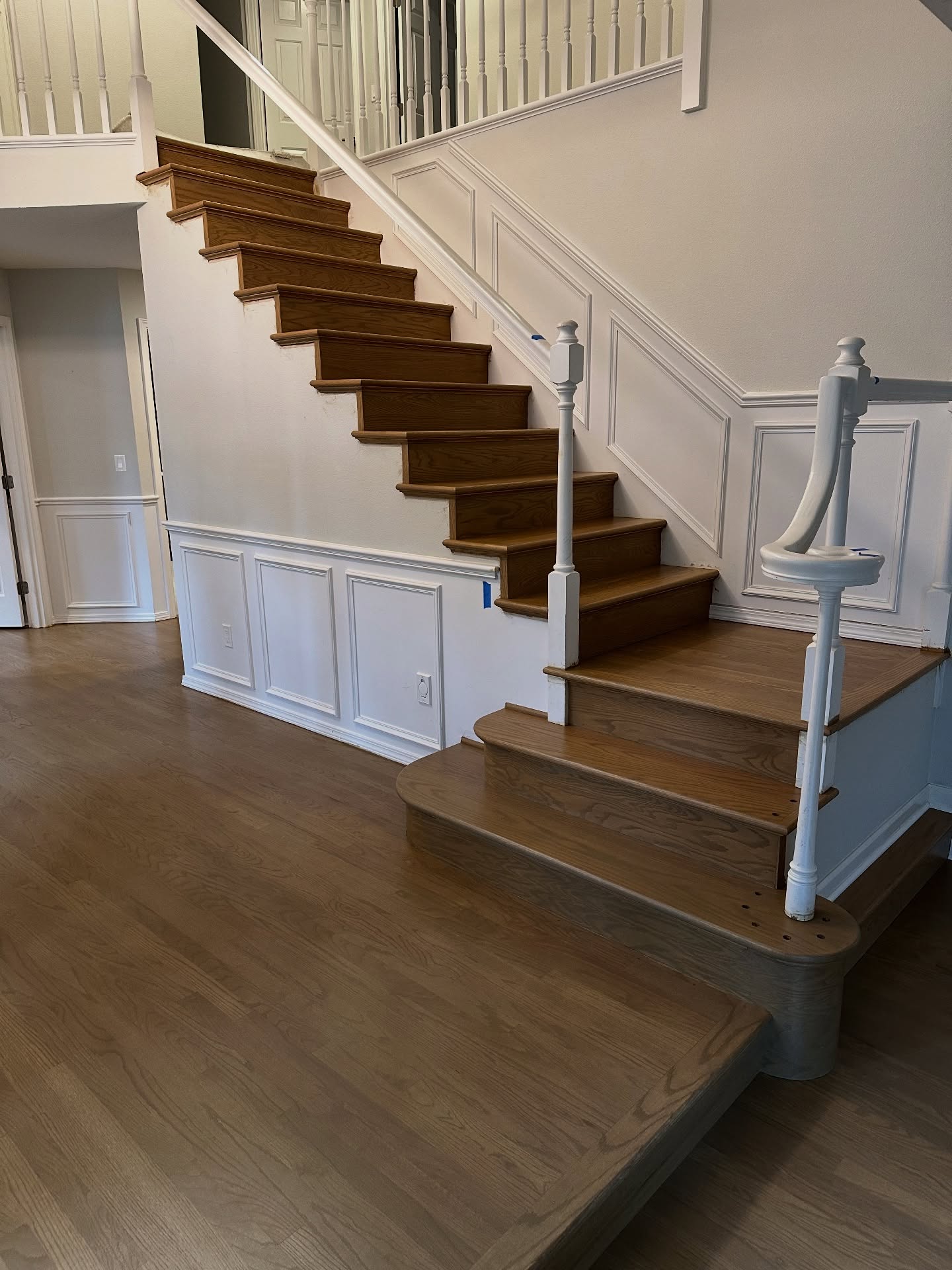 Traditional staircase refinished with white risers and stained oak treads